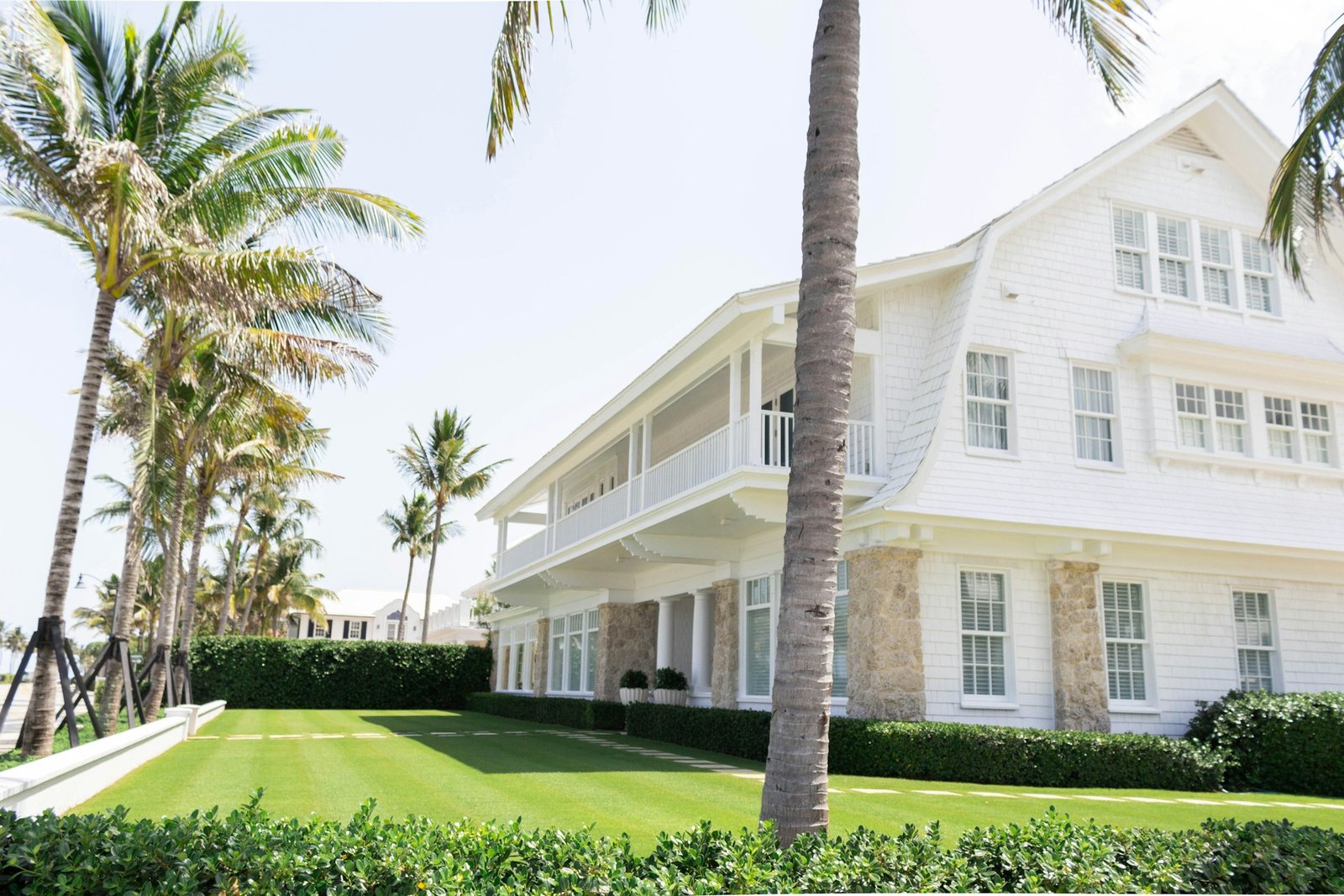 White Florida home surrounded by palm trees